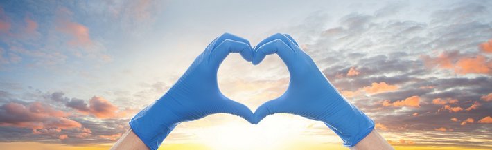 Bild mit Herz aus Hand mit Handschuhen
